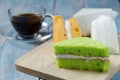 Pandan and coconut chiffon cake on a wooden plate Royalty Free Stock Photo