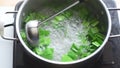 Pandan drink making,stirring pandan leaf in boiled water by stanless ladle