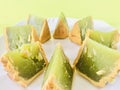 Pandan moon cake cut into eighths , green background. Close up. Royalty Free Stock Photo