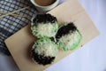 Pandan steamed sponge cake topped with cheese and chocolate sprinkles with a sweet taste and soft texture.