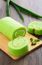 Pandan swiss roll cake on wooden table