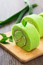 Pandan swiss roll cake on wooden table Royalty Free Stock Photo