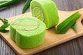 Pandan swiss roll cake on wooden table