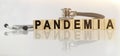 PANDEMIA the word on wooden cubes, cubes stand on a reflective white surface, on cubes - a stethoscope