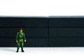 Lockdown illustration Ã¢â¬â miniature soldier stand guard in front of barrier wall.