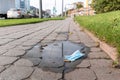 Pandemic in Kaliningrad, Russia. A lost blue face mask lies on the ground on Moskovsky Prospekt in Kaliningrad Royalty Free Stock Photo
