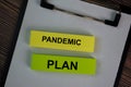 Pandemic Plan write on sticky notes isolated on Wooden Table Royalty Free Stock Photo