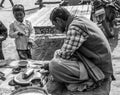 A pandit is waiting for jajman at his shop.