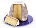 Pandoro with slice on blue plate Royalty Free Stock Photo
