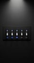A panel of five black and silver toggle switches is mounted on a dark wall, each Royalty Free Stock Photo