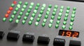 Panel with a metallic surface displays rows of small green and red Royalty Free Stock Photo