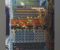 Panel modern communications equipment behind bars the door chassis with the display in the data center Royalty Free Stock Photo