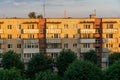 Panel residential building surrounded by greenery and trees. A green city in an ecologically clean area. The house is flooded with Royalty Free Stock Photo