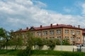 Panel residential building surrounded by greenery and trees. A green city in an ecologically clean area. The house is flooded with Royalty Free Stock Photo