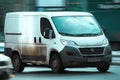 panel van Fiat Ducato 130 Multijet speeding on road. White dirty delivery van in motion on the street, side view