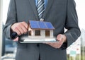 panels on the roof houses on tablet of the businessman