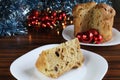 Panettone slice closeup. Plate with slice of panettone with Christmas decorations.