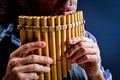 Panflute old played in his hand Royalty Free Stock Photo