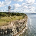 Panga coastal cliff and lighthouse Panga pank, Saaremaa island, near Kuressaare, Estonia. North-Estonian limestone escarpment,