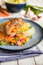 Pangasius fillets rolls stuffed with carrot and olives, served with vegetable salad and boiled potato