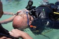 Panglao, Philippines - April 29, 2021: Scuba diver, instructor in confined water teaching, studying, evaluating skills, rescue ski