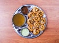 pani puri or gol gappay with raita, sweet sauce and spicy water served in dish isolated on table top view of indian and pakistani
