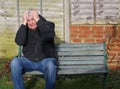 Panic attack man on a bench. Royalty Free Stock Photo