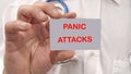 Panic attacks the text on the card of a man in a white shirt Royalty Free Stock Photo