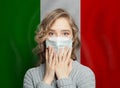 Panicking Italian woman in face mask against Italy flag. Flu epidemic and virus protection concept