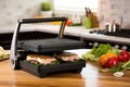 panini press showing grill side and handle