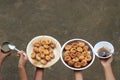 Panipuri with tamarind chutney and mint water held in a row on hand, homemade golgappe dish which is popular indian street food Royalty Free Stock Photo