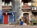 Exterior facade of an old rustic weathered building with vintage balconies in the Fontainhas