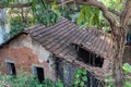 Top angle view of an old rustic dilapidated house with broken tiled roofs