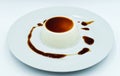 Panna Cotta with caramel sauce on a white plate. Delicious italian dessert Royalty Free Stock Photo