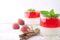 Panna cotta dessert with strawberry jelly on rustic wooden backg