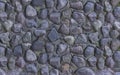 Panne light gray dark stones stacked wall of old dried fountain weathered textured closeup background