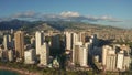 Panning aerial drone slowly flying over a colorful Honolulu Skyline while Sunset in Oahu, Hawaii with Waikiki Beach Royalty Free Stock Photo