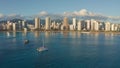 Panning aerial drone slowly flying over a colorful Honolulu Skyline while Sunset in Oahu, Hawaii with Waikiki Beach Royalty Free Stock Photo