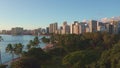 Panning aerial drone slowly flying over a colorful Honolulu Skyline while Sunset in Oahu, Hawaii with Waikiki Beach Royalty Free Stock Photo