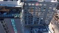 Panning aerial footage of Reverb by Hard Rock with skyscrapers and office buildings in the city skyline