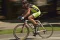Panning of a cyclist riding bicycle in a sunny day, competing for Road Grand Prix event, a high-speed circuit race in