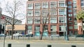 panning footage along King Street in front of Oracle Park with office buildings, restaurants, retails stores and cars driving