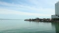 panning footage of McCovey Cove and Oracle Park with blue ocean water, boats and people walking with blue sky and clouds