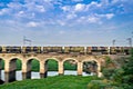 Panning image of petrol tanker train passing on old bridge in Dapodi, Pune, India Royalty Free Stock Photo