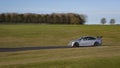 A silver BMW sportscar speeding round corners