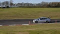 A silver BMW sportscar speeding round corners