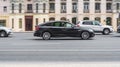 Panning shot of black car running on the city road. BMW 5 Series F07 Gran Turismo drive on the streets Royalty Free Stock Photo