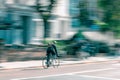 Panning shot of a male in a backpack cycling on the Oxford Road in Manchester, UK