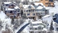 Pano Aerial view of snowy neighborhood in winter on a mountain town with houses Royalty Free Stock Photo