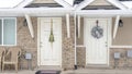 Pano Apartment entrances with christmas wreaths hanging on the white front doors